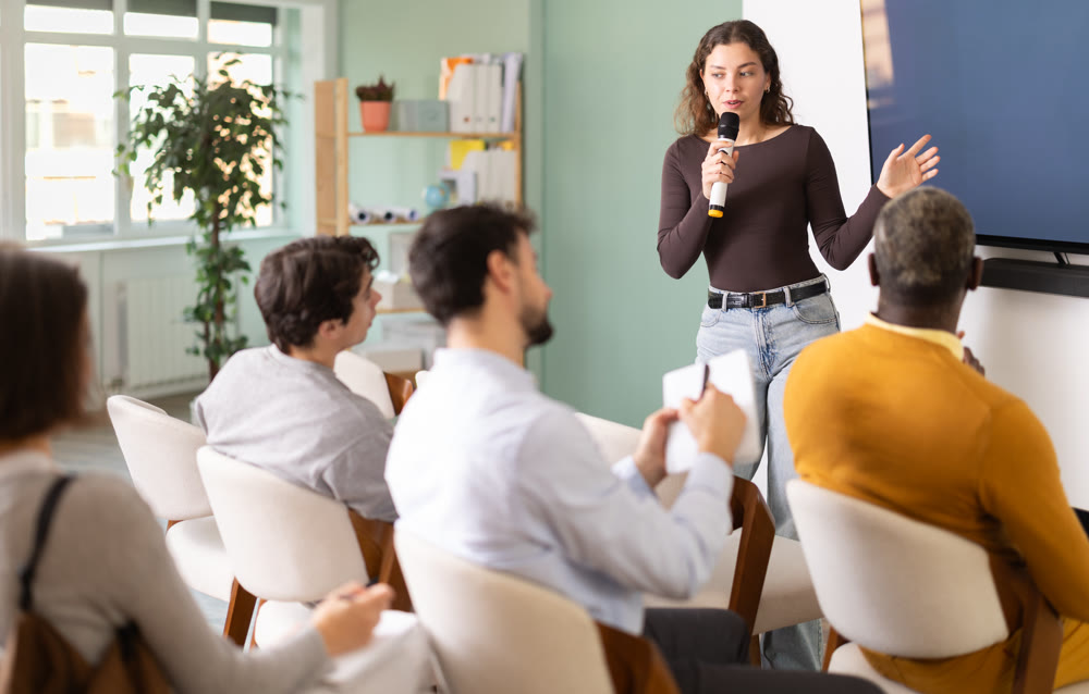 During lesson, girl teacher tells material and gives lecture