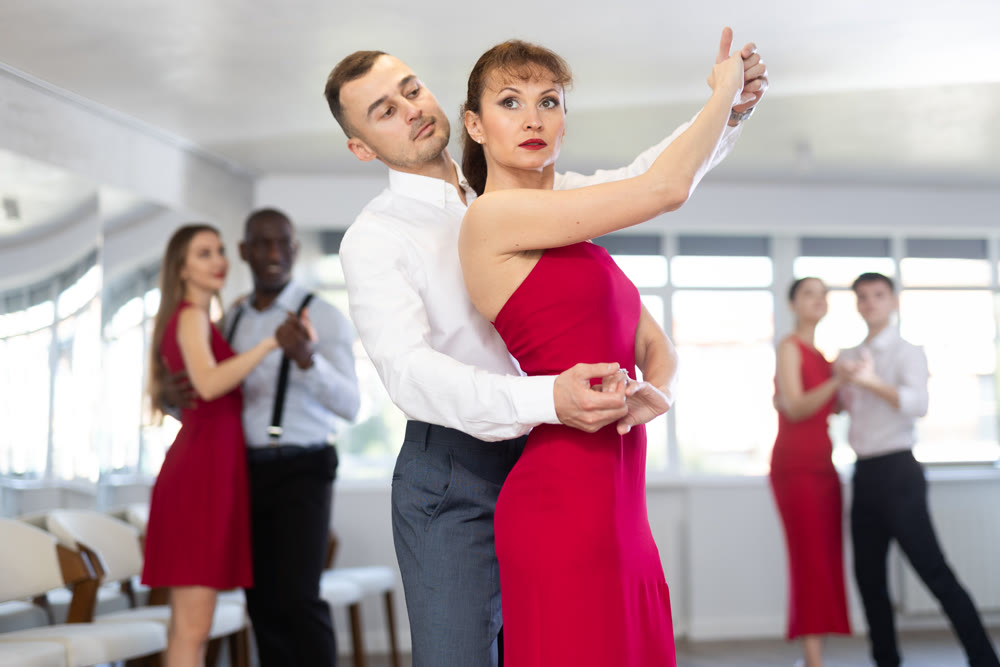 Adult man and adult woman dance waltz