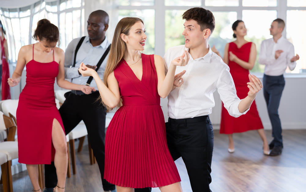 Young guy and young woman dance twist