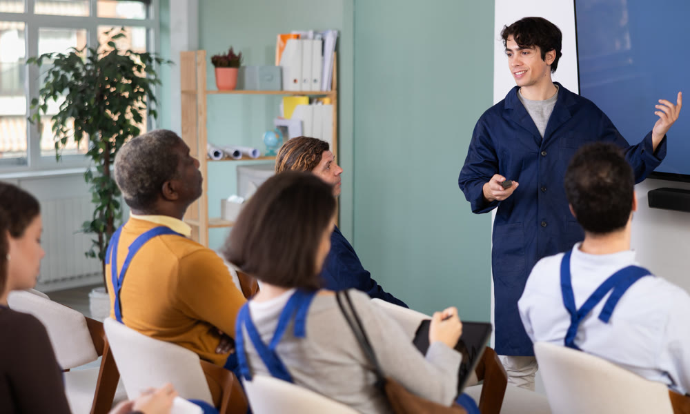 Male teacher conducts professional development lesson for workers