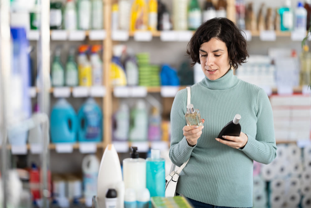 Middle-aged woman choosing perfume at department store