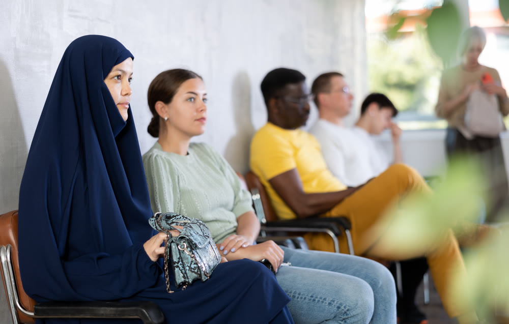 Young arab woman waiting in line at reception