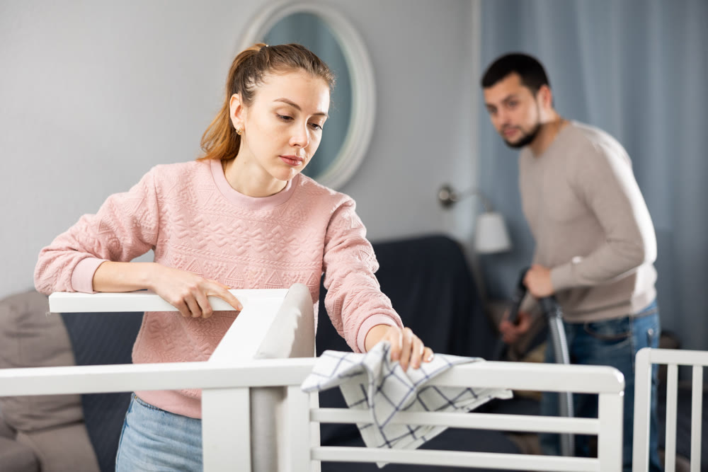 Wife and husband cleaning up in apartment
