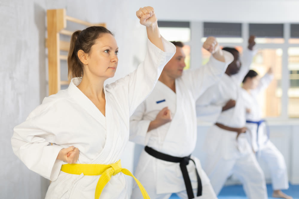 Group of multiethnic people training karate techniques