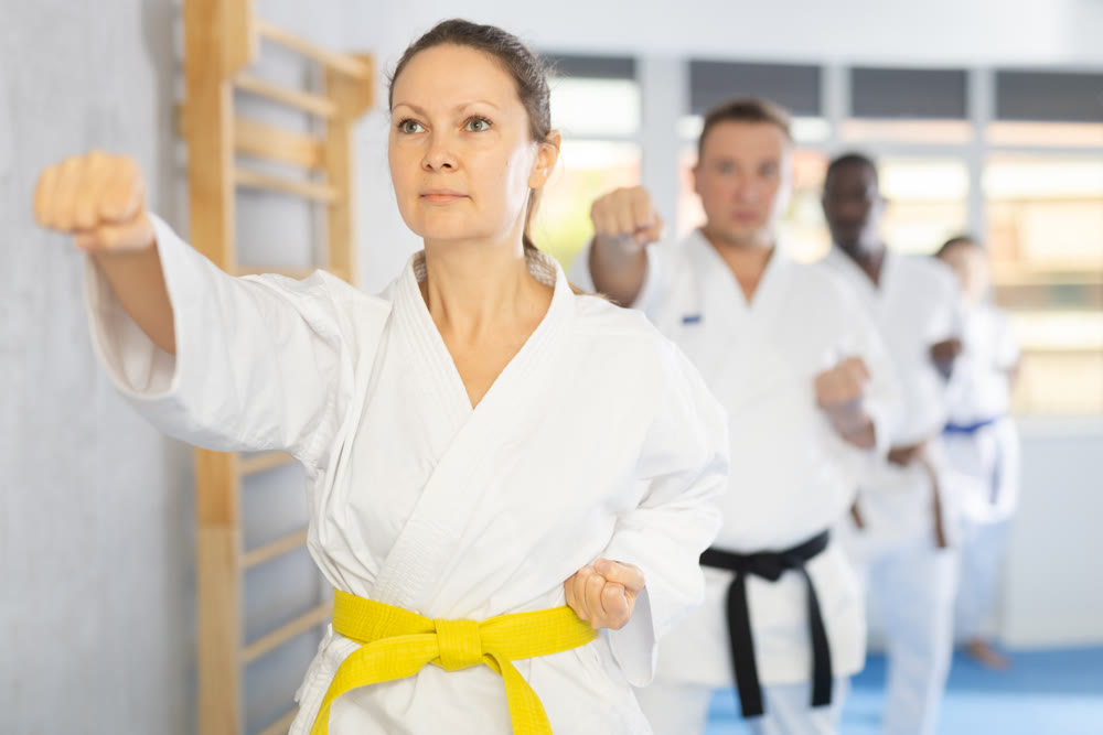 Group of multiethnic people training karate techniques