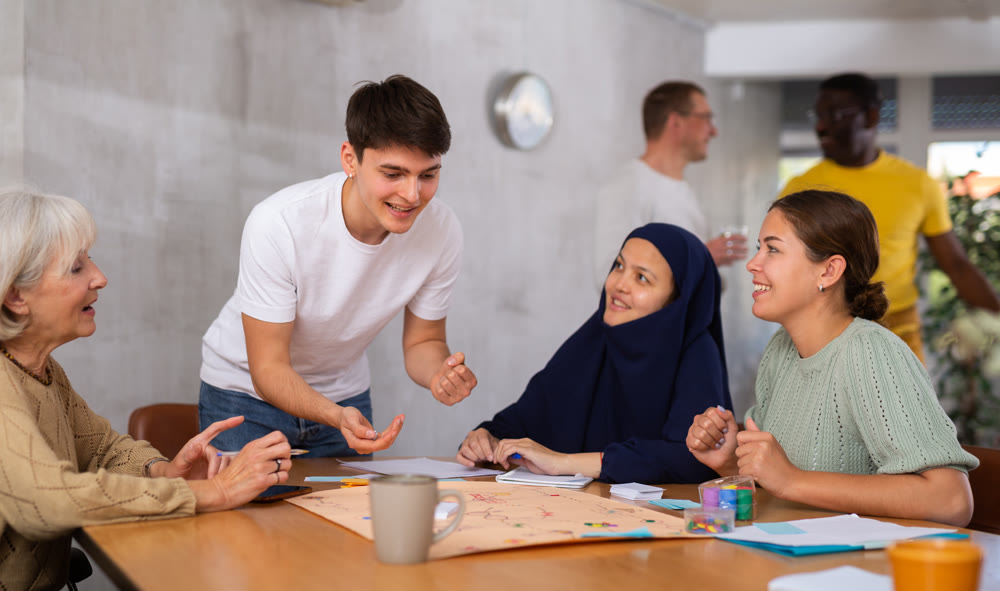 Group of multinational people playing board game