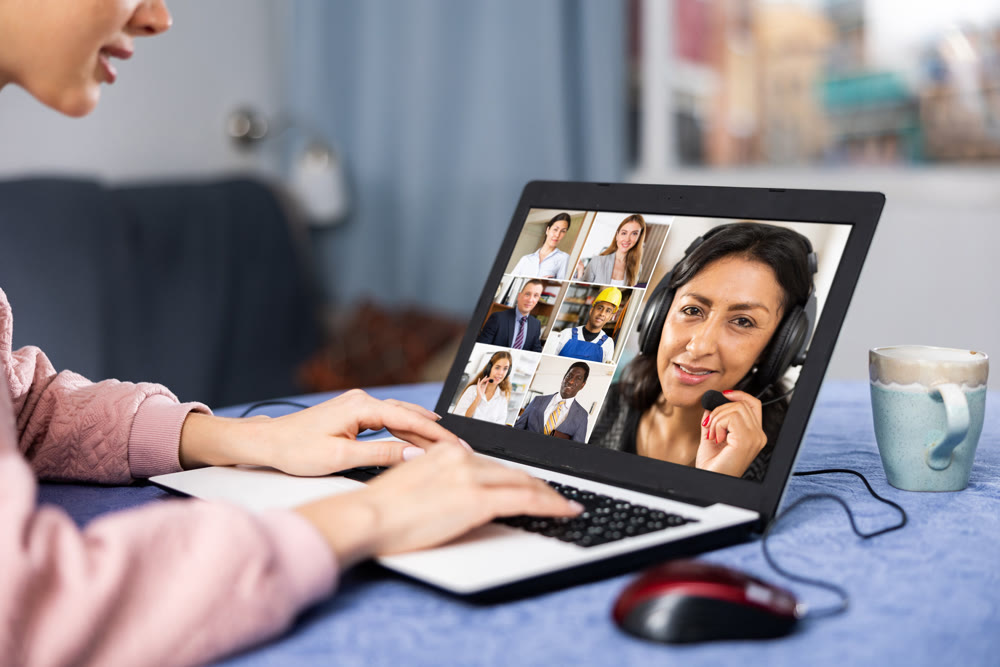 Young woman is holding a video conference on a laptop