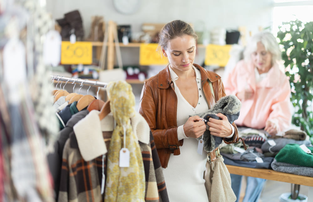 During November sales, woman choose and buy fur hat