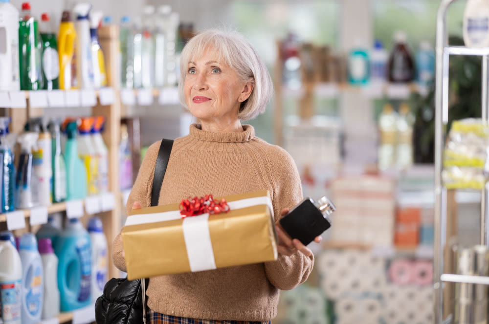 Mature woman holding present in department store