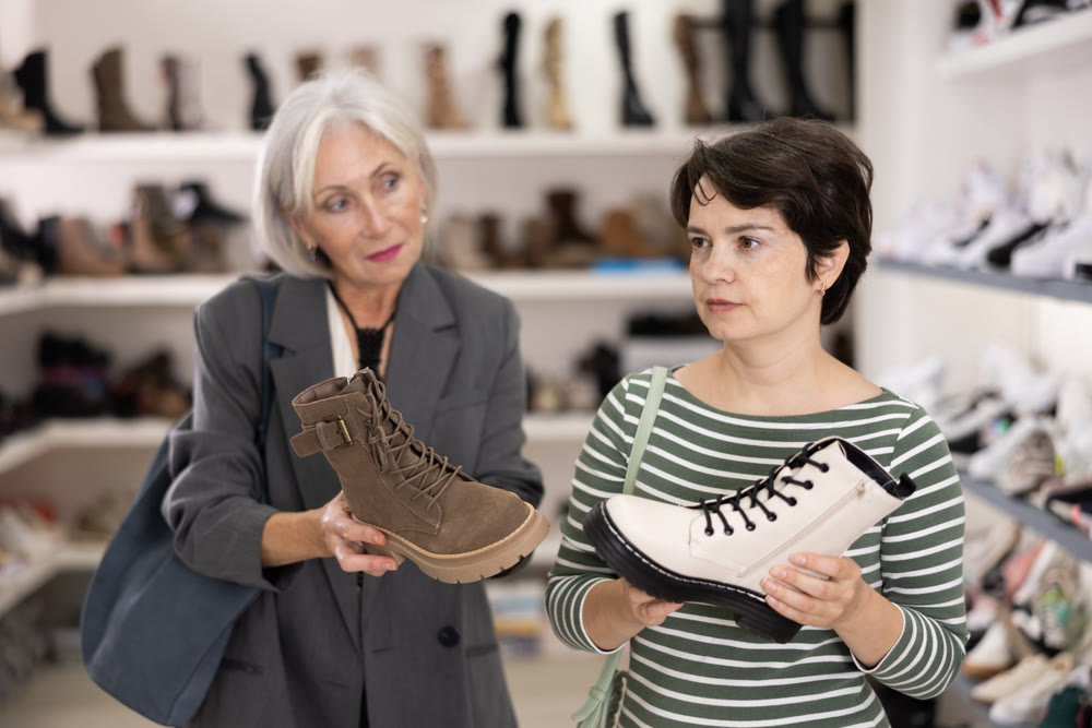 Two women are shopping in shoe store