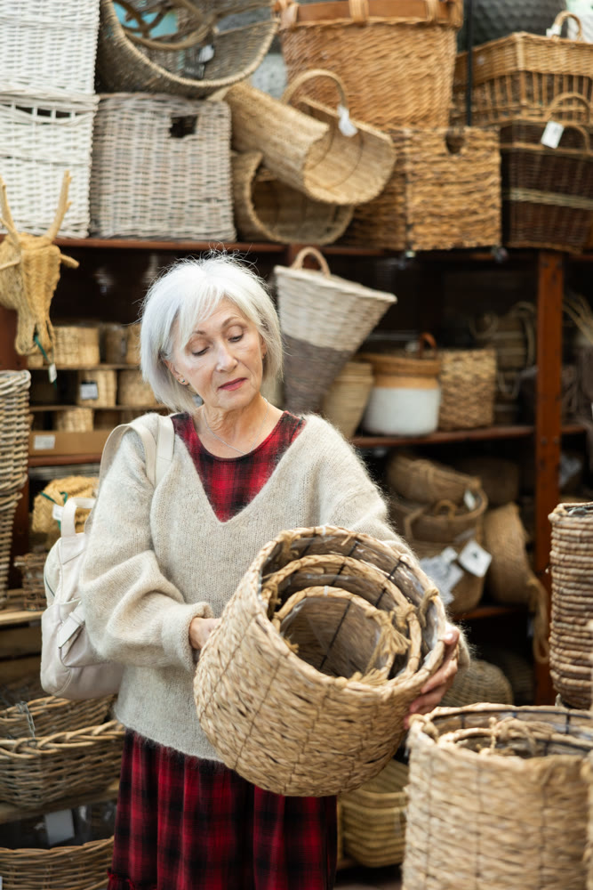 Elderly woman choosing basket in store
