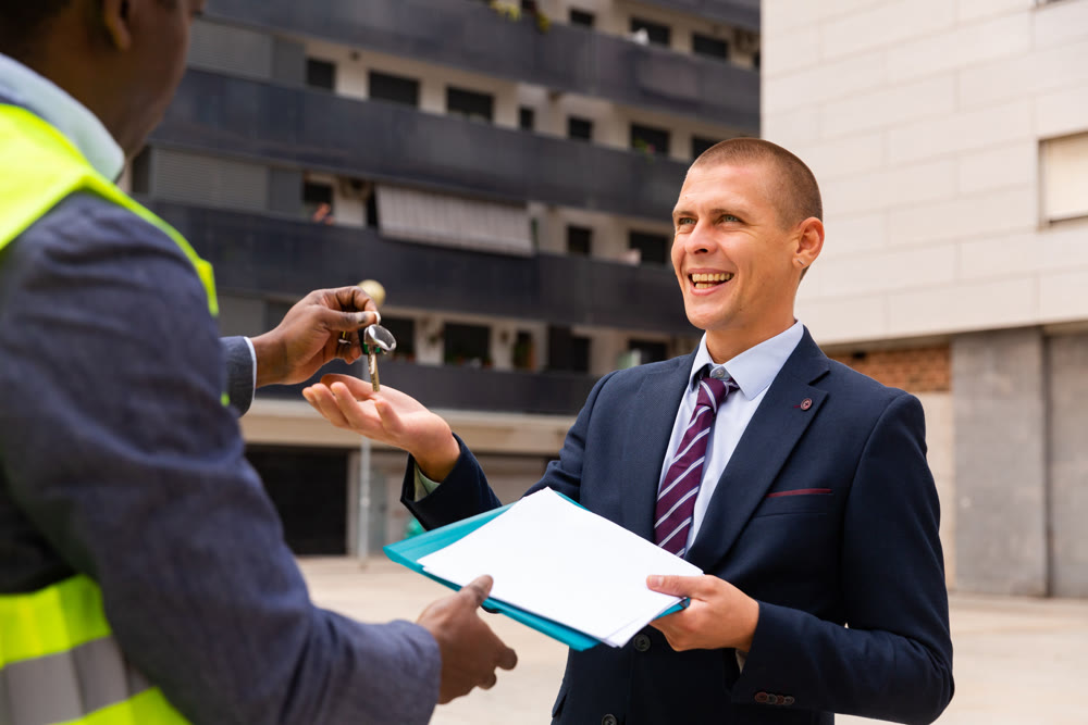 Man reciveing keys to new apartment from engineer