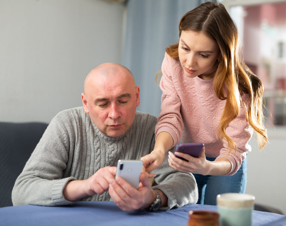 Married couple understand the settings of a mobile phone