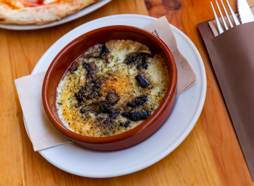 Provolone cheese baked with mushrooms seasoned with Italian herbs