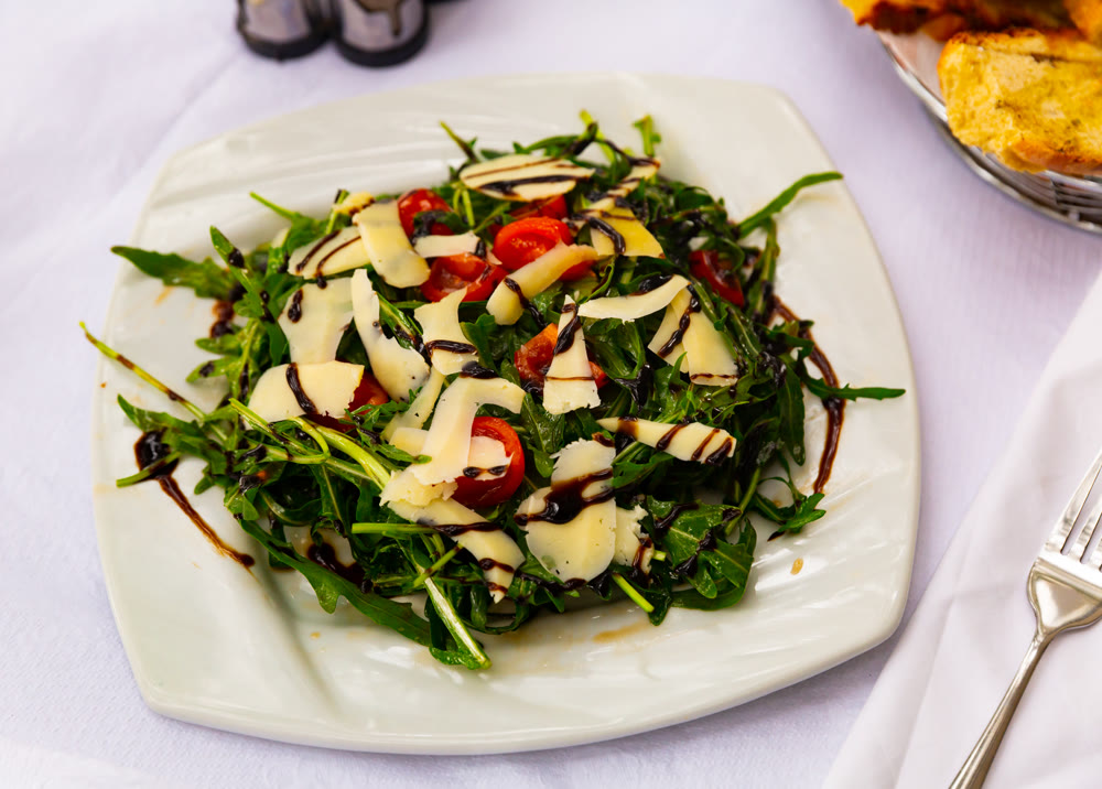 Fresh vegetable salad with arugula and cheese