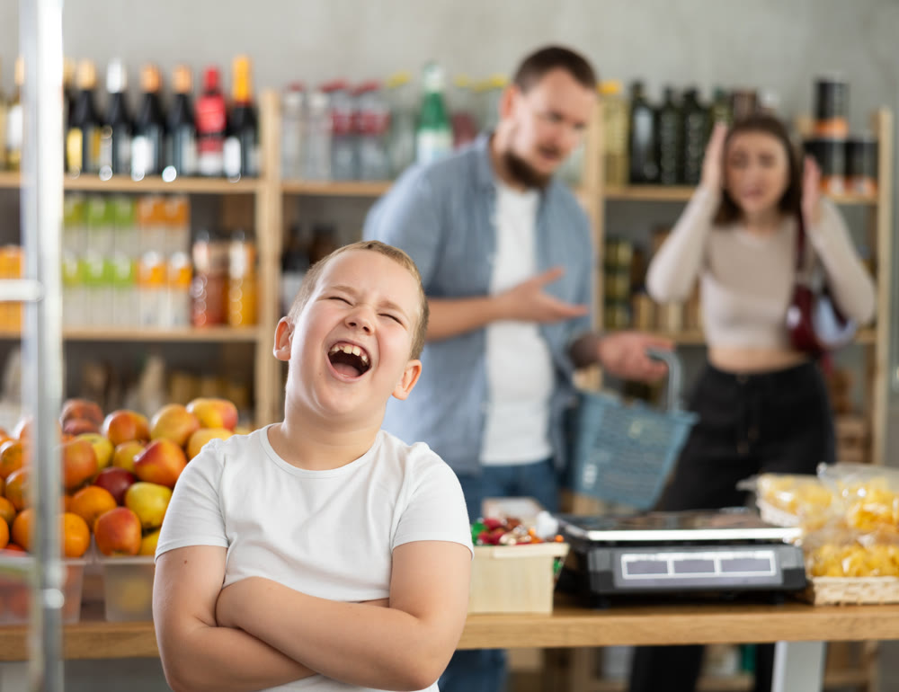Capricious preteen boy screaming loudly in grocery store