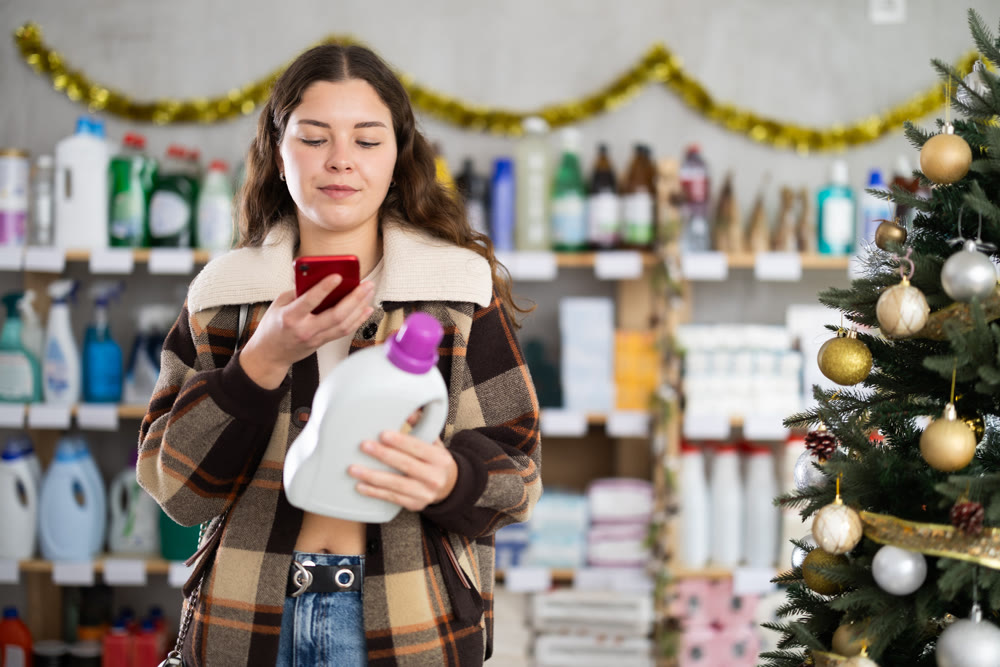 Young woman scanning qr code for detergent