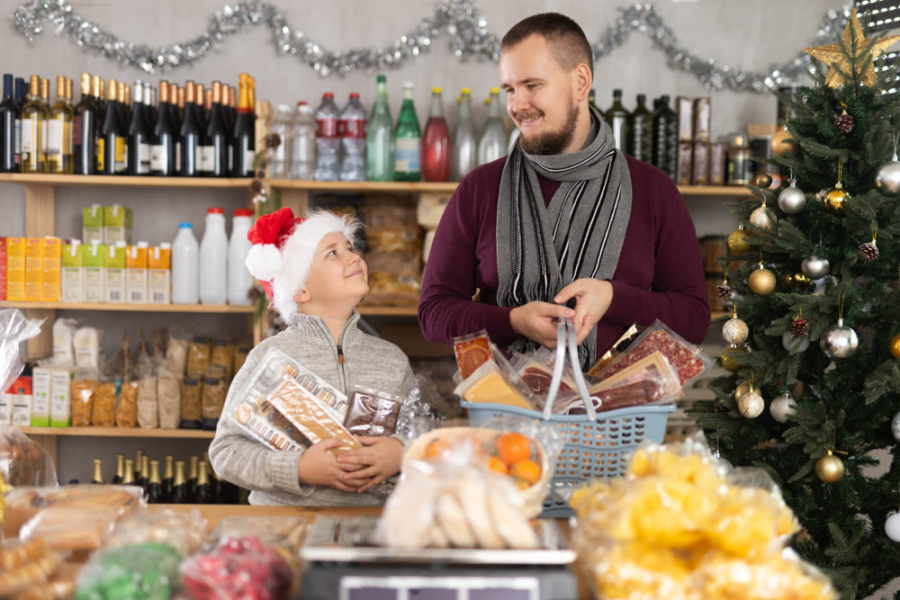 Father and son shopping for holiday celebration in festive market