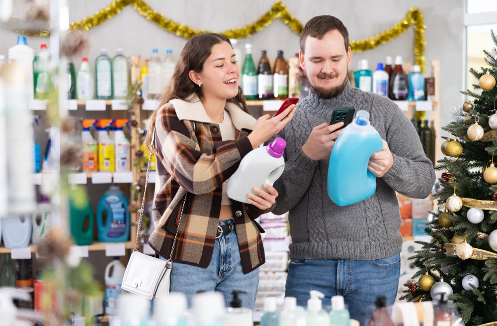 Married couple checking expiration date of detergent using smartphone