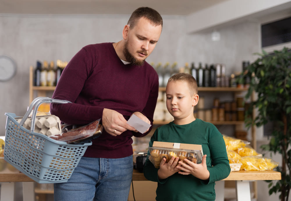 Man and his son are shopping on a list