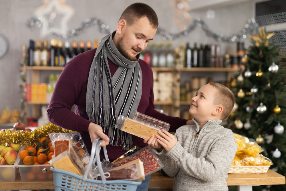 Father and son shopping for holiday celebration in festive market