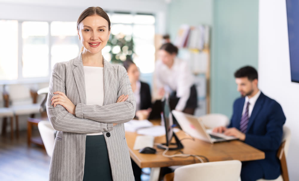 Young woman welcoming clients at workplace