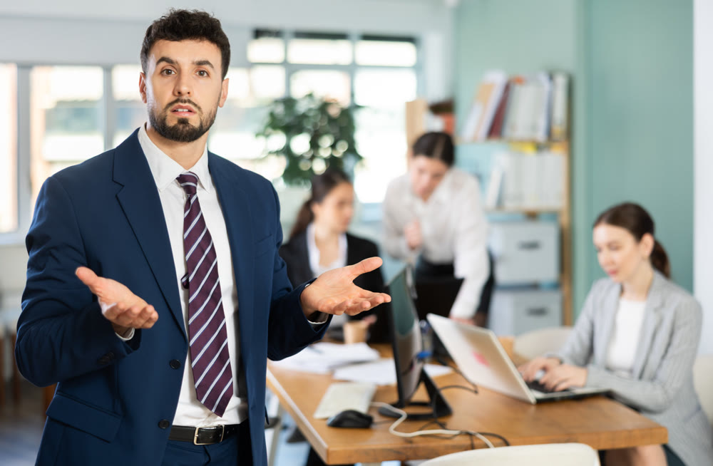 Confused young man while working in office