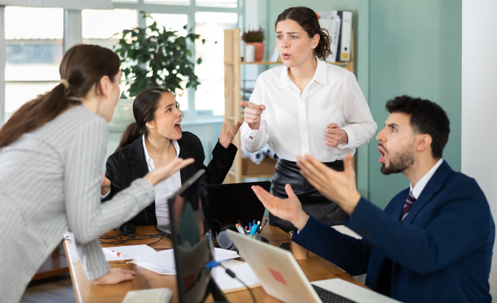 Group of men and women arguing loudly in office