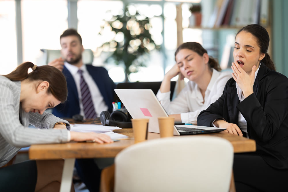 Group of colleagues feeling tired during a long workday