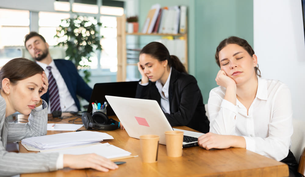 Group of colleagues feeling tired during a long workday