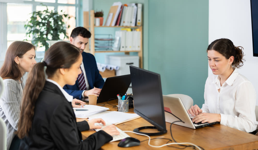 Group of young colleagues working in office
