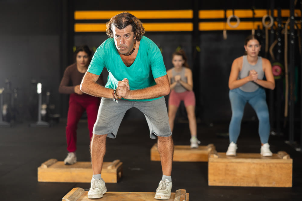 man at a Crossfit training steps on a box