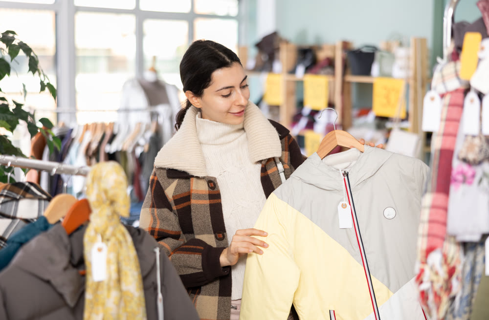 Regular customer Armenian woman chooses color and style of down jacket