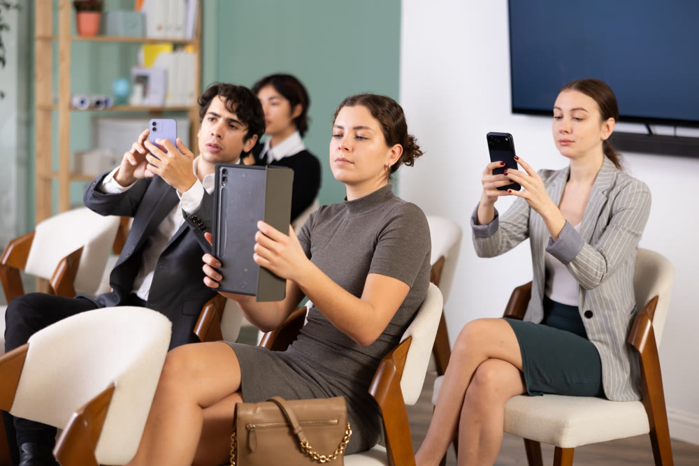 Colleagues scan QR code or take photo of presentation in meeting room