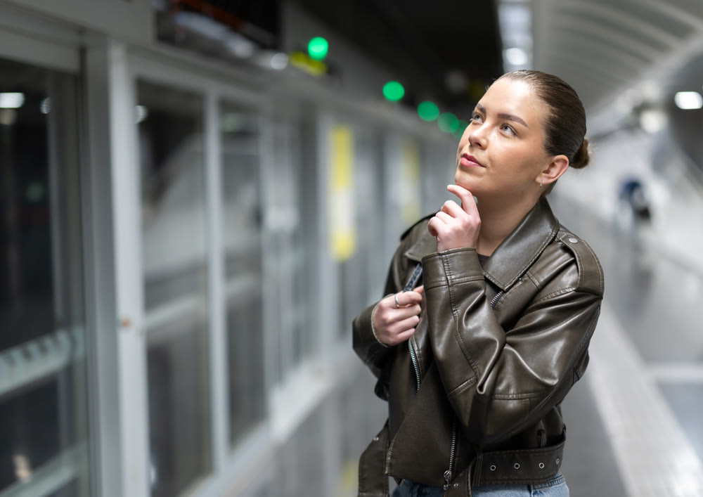 Pretty girl walks along the platform waiting for subway train