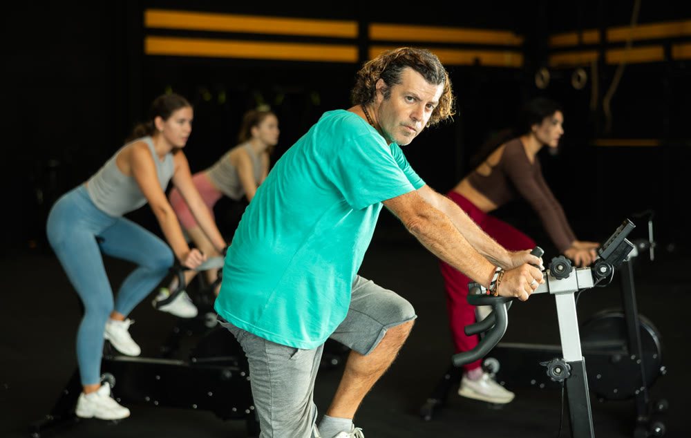 man doing exercises on a bicycle simulator during a crossfit workout