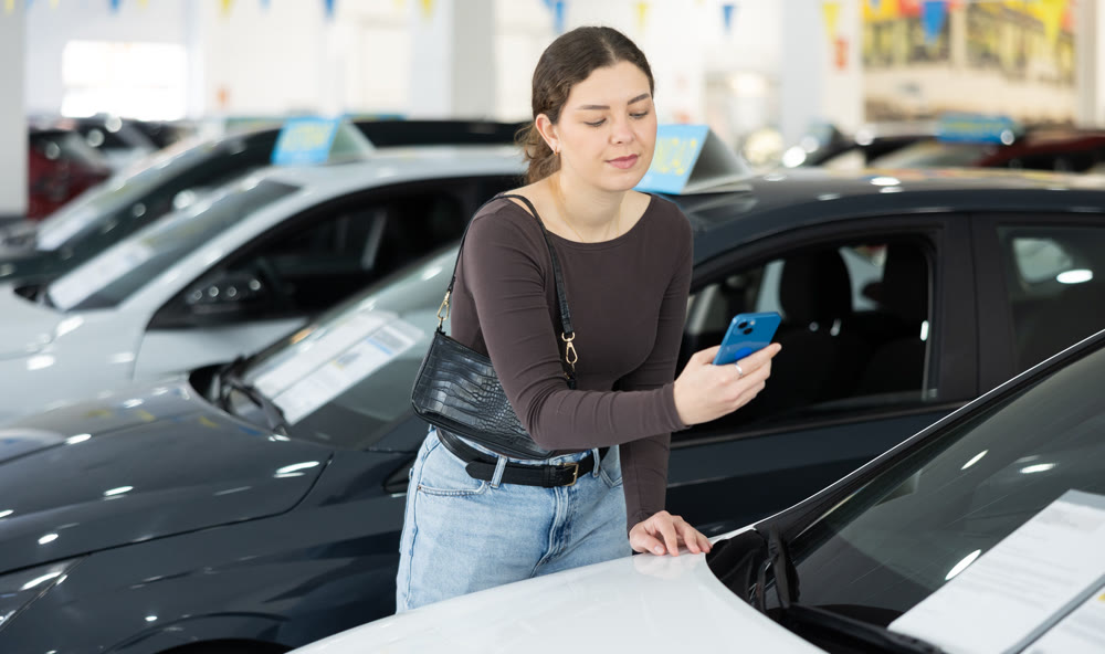 woman scans the barcode of the car and looks at the detailed information