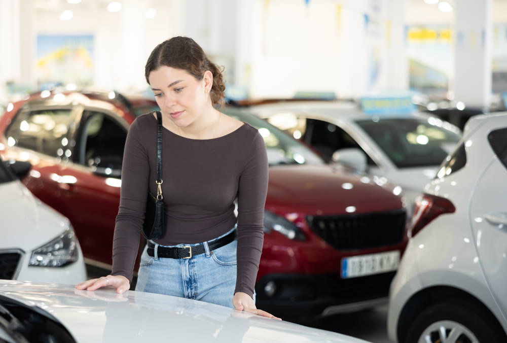 woman choosing a car in a car dealership