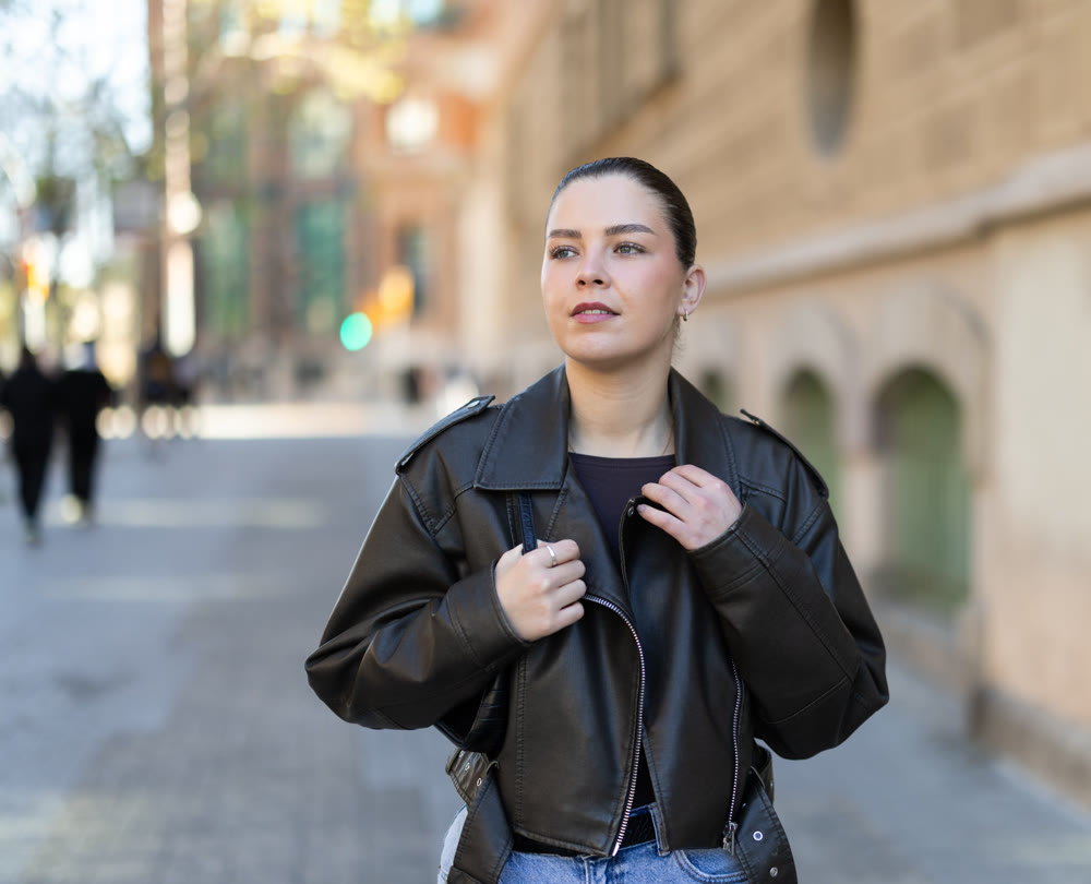 Young woman walks along city street