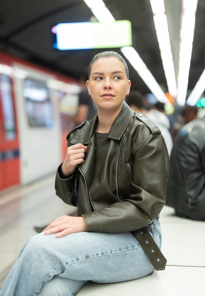 Young woman sitting at subway station