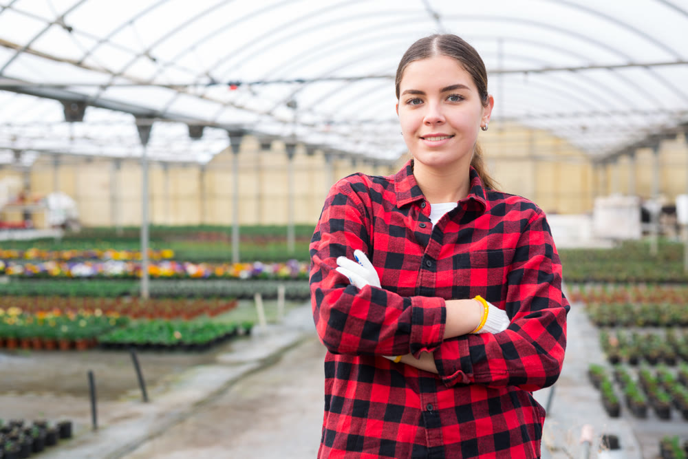 Female florist posing at greenhouse