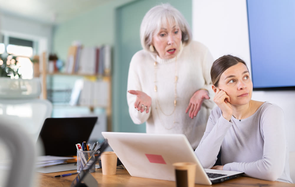 Mature female manager is dissatisfied with the work of an employee - she yells and reproaches her