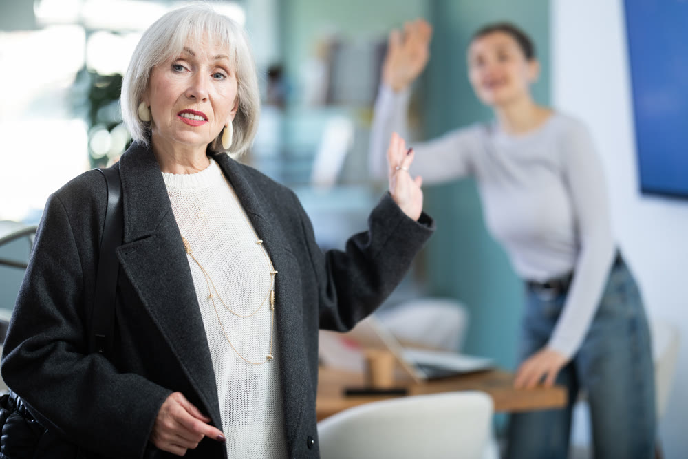 Senior woman says goodbye to colleague at end of working day