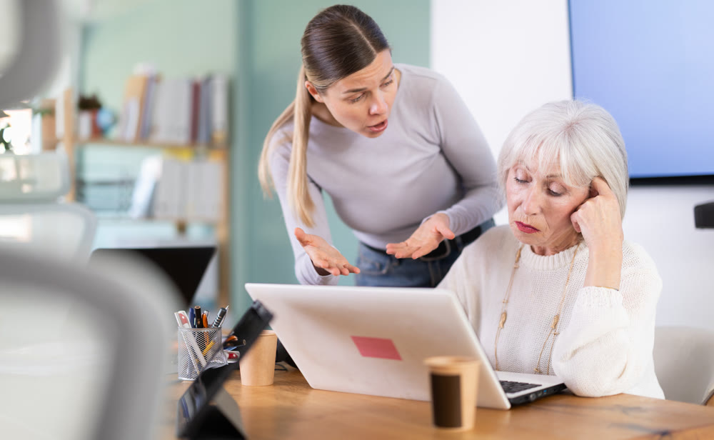 Female boss scolds an mature subordinate for errors in documents