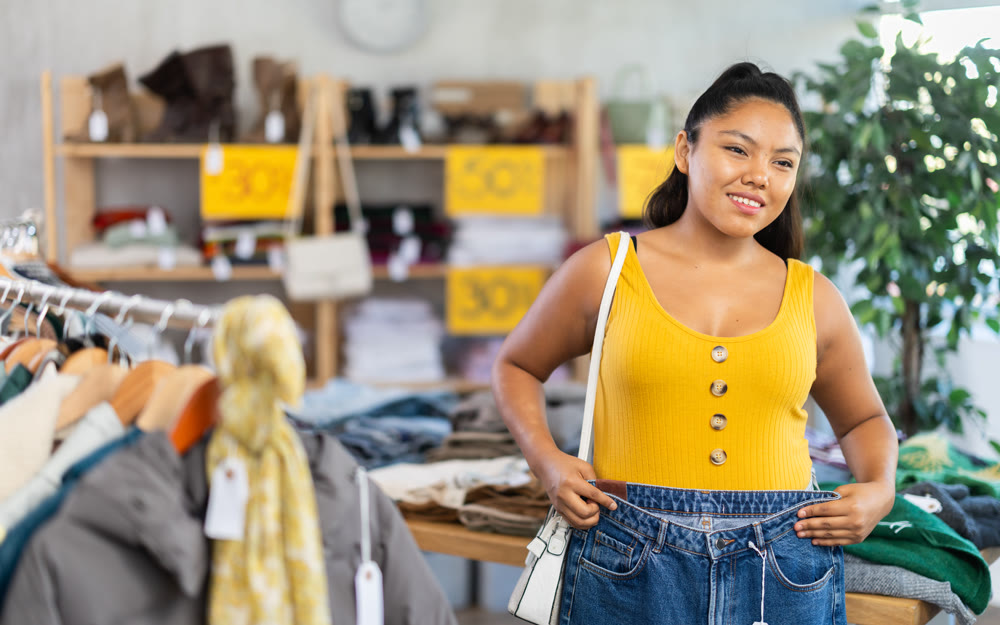 Girl at trading floor pick out and buying jeans trousers