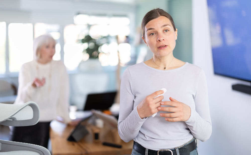 Elderly woman scolds adult woman in office