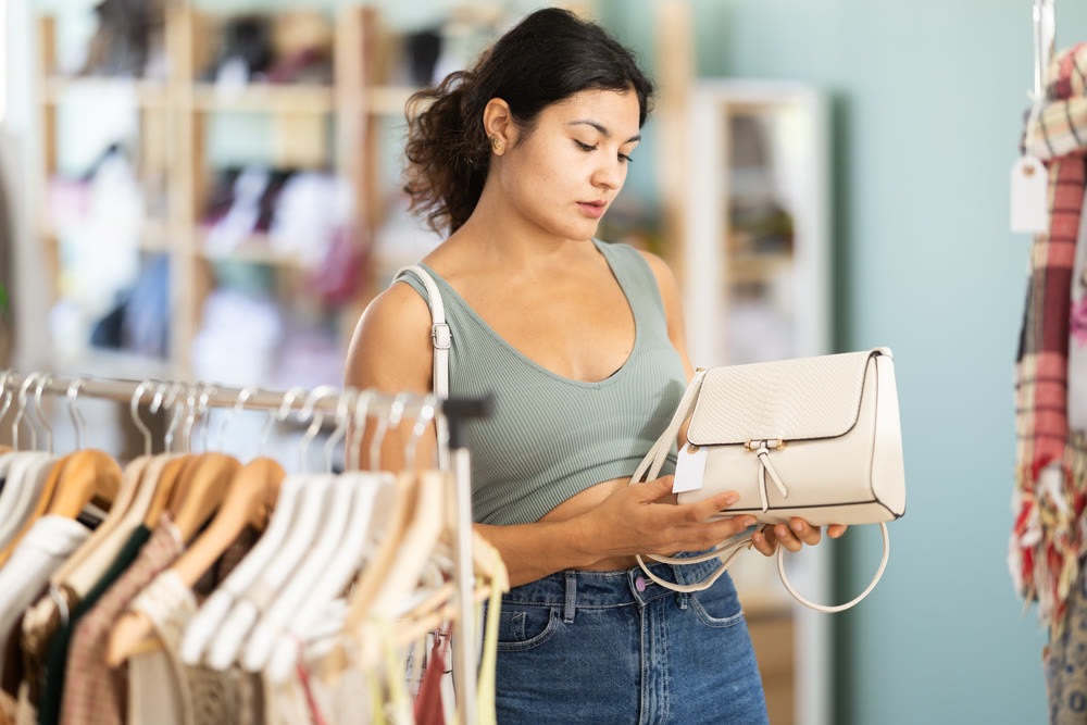 Young woman chooses bra in fashionable clothing boutique