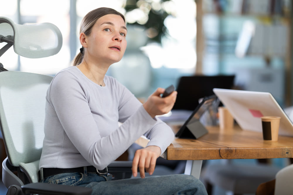 Adult and elderly women watching presentation in office