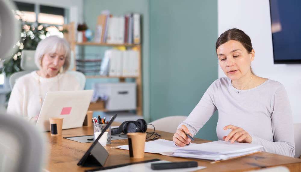 Adult woman taking notes in document