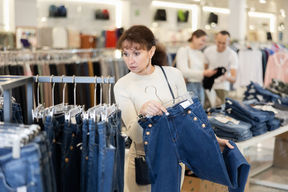 Adult woman choosing jeans in store